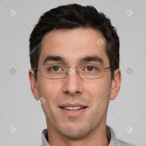 Joyful white adult male with short  black hair and brown eyes