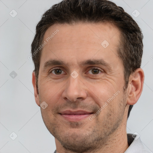 Joyful white adult male with short  brown hair and brown eyes