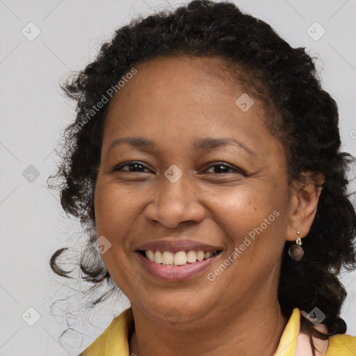 Joyful black adult female with long  brown hair and brown eyes