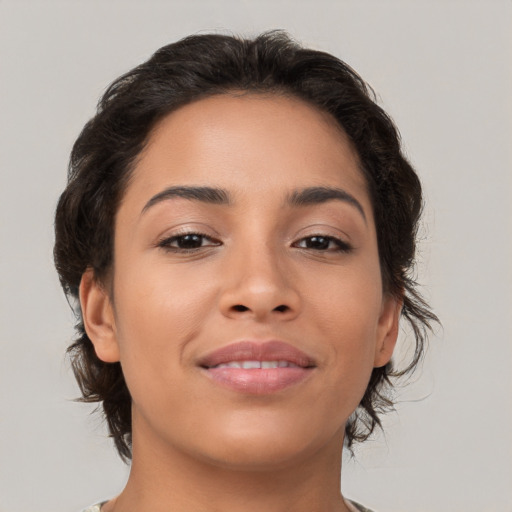 Joyful latino young-adult female with medium  brown hair and brown eyes