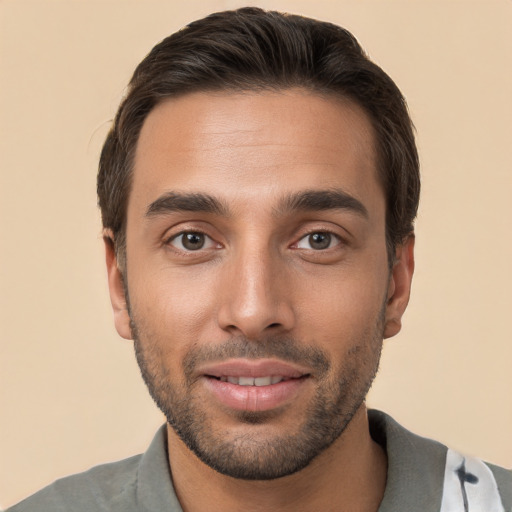 Joyful white young-adult male with short  brown hair and brown eyes