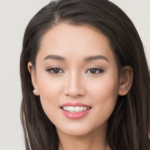 Joyful white young-adult female with long  brown hair and brown eyes