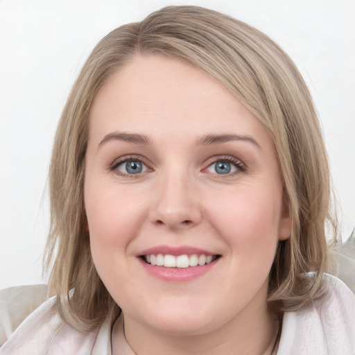 Joyful white young-adult female with medium  brown hair and blue eyes