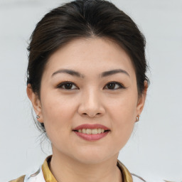 Joyful asian young-adult female with medium  brown hair and brown eyes