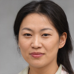 Joyful asian adult female with medium  brown hair and brown eyes