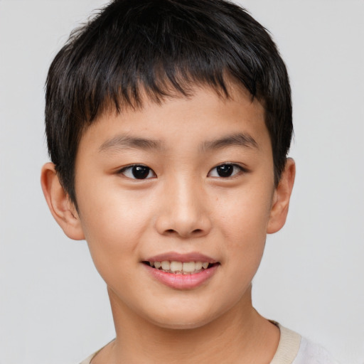 Joyful asian child male with short  brown hair and brown eyes
