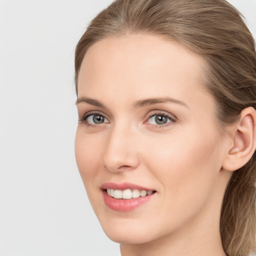 Joyful white young-adult female with long  brown hair and grey eyes