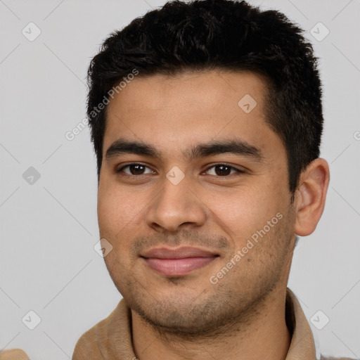 Joyful latino young-adult male with short  black hair and brown eyes