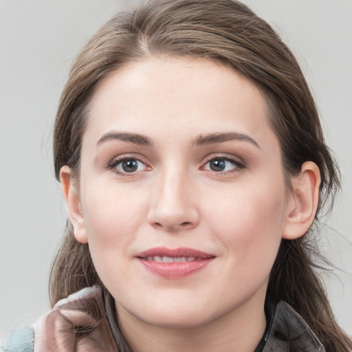 Joyful white young-adult female with long  brown hair and grey eyes