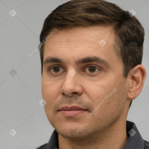 Joyful white adult male with short  brown hair and brown eyes