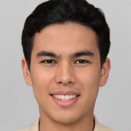 Joyful latino young-adult male with short  brown hair and brown eyes