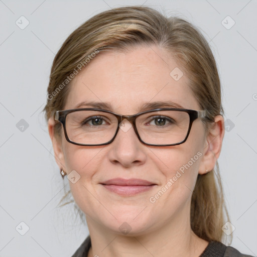 Joyful white adult female with medium  brown hair and blue eyes