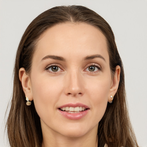 Joyful white young-adult female with long  brown hair and grey eyes