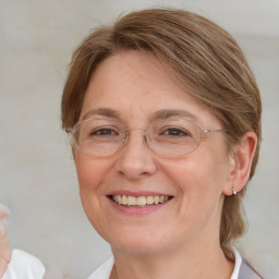 Joyful white adult female with medium  brown hair and blue eyes