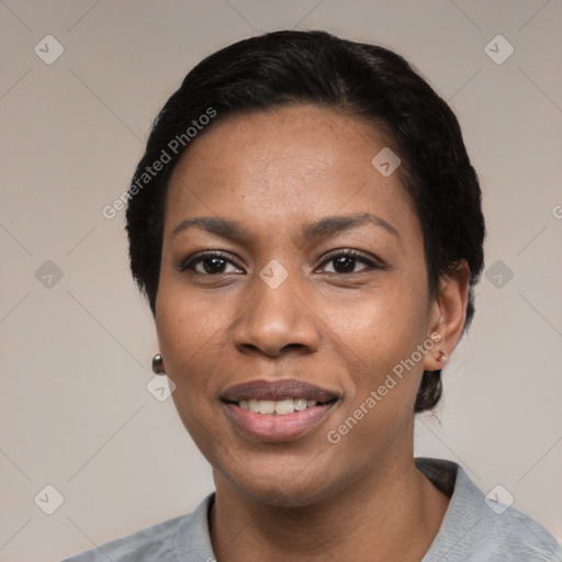 Joyful black young-adult female with short  black hair and brown eyes