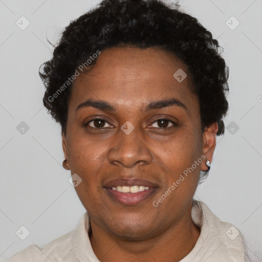 Joyful black adult female with short  black hair and brown eyes