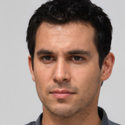 Neutral white young-adult male with short  black hair and brown eyes