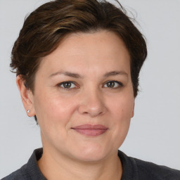 Joyful white adult female with medium  brown hair and brown eyes