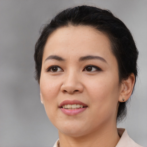 Joyful asian young-adult female with medium  black hair and brown eyes