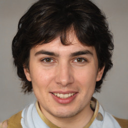 Joyful white young-adult male with medium  brown hair and brown eyes