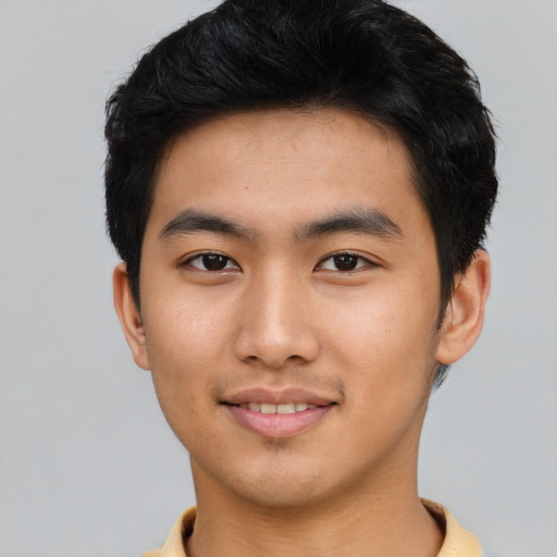 Joyful asian young-adult male with short  black hair and brown eyes