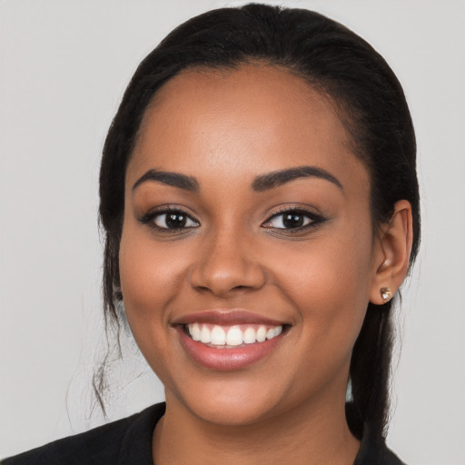 Joyful latino young-adult female with long  black hair and brown eyes