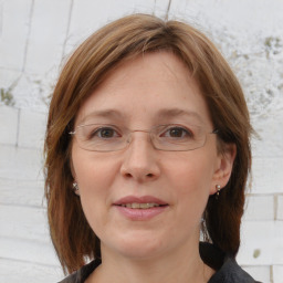 Joyful white adult female with medium  brown hair and brown eyes