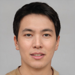 Joyful asian young-adult male with short  brown hair and brown eyes