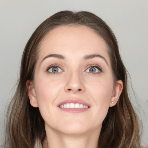 Joyful white young-adult female with long  brown hair and grey eyes