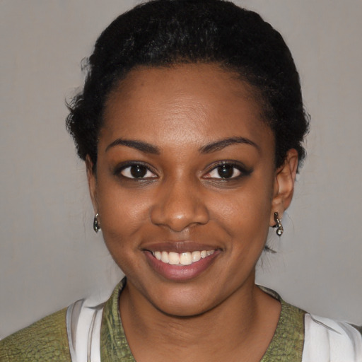 Joyful black young-adult female with short  black hair and brown eyes