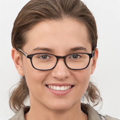 Joyful white young-adult female with medium  brown hair and grey eyes