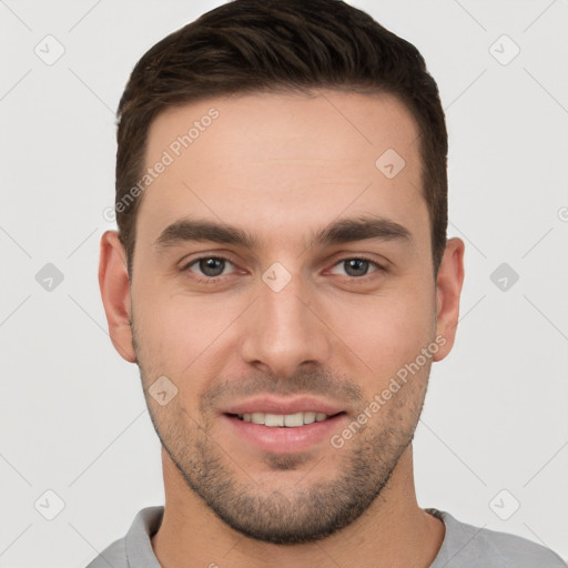 Joyful white young-adult male with short  brown hair and brown eyes