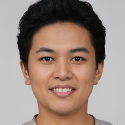 Joyful asian young-adult male with short  black hair and brown eyes