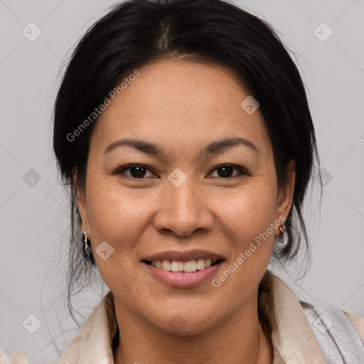 Joyful latino adult female with medium  brown hair and brown eyes