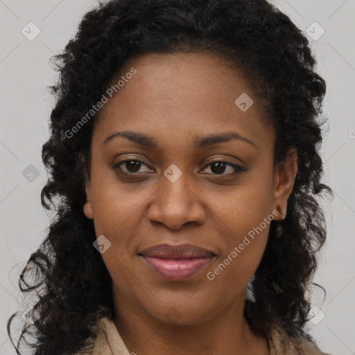 Joyful black adult female with long  brown hair and brown eyes