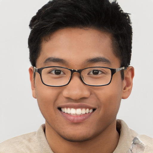 Joyful latino young-adult male with short  brown hair and brown eyes