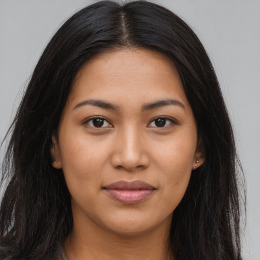 Joyful latino young-adult female with long  brown hair and brown eyes