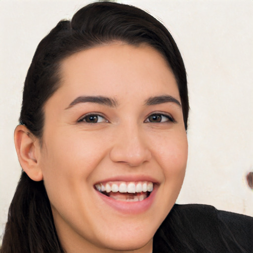 Joyful white young-adult female with long  black hair and brown eyes