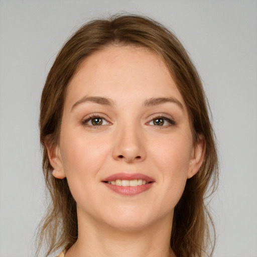 Joyful white young-adult female with long  brown hair and grey eyes