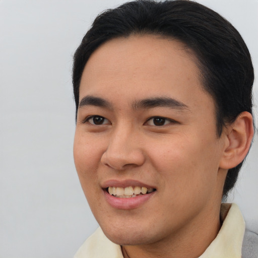 Joyful asian young-adult male with short  brown hair and brown eyes