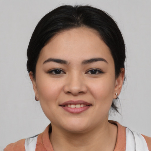 Joyful white young-adult female with medium  black hair and brown eyes