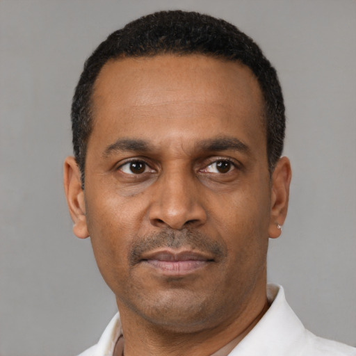 Neutral latino adult male with short  black hair and brown eyes