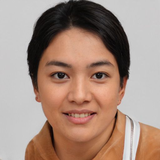 Joyful asian young-adult female with short  brown hair and brown eyes