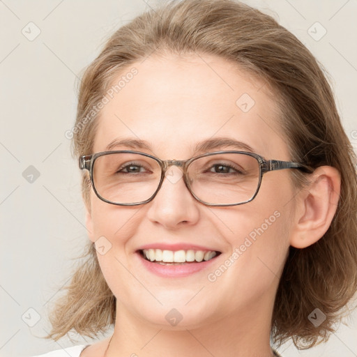 Joyful white adult female with medium  brown hair and blue eyes