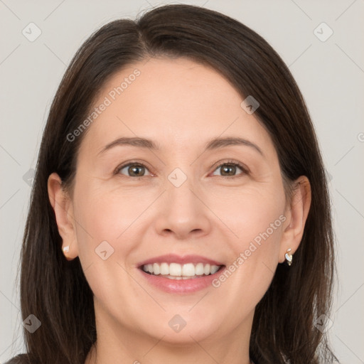 Joyful white adult female with medium  brown hair and brown eyes