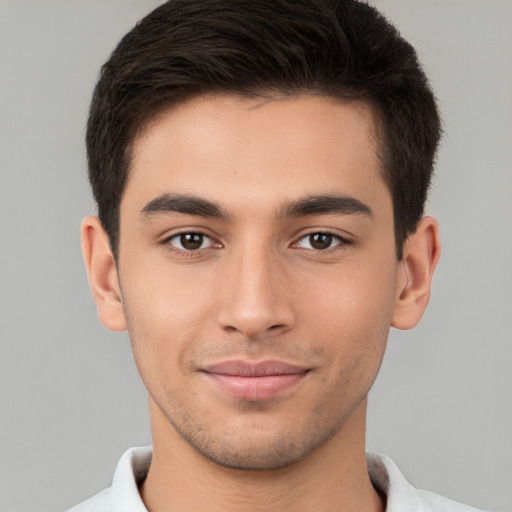 Joyful white young-adult male with short  brown hair and brown eyes