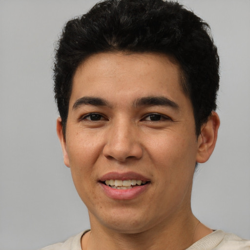 Joyful white young-adult male with short  black hair and brown eyes