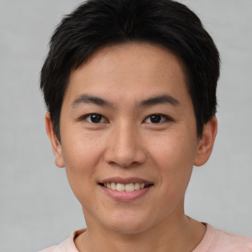 Joyful asian young-adult female with short  brown hair and brown eyes