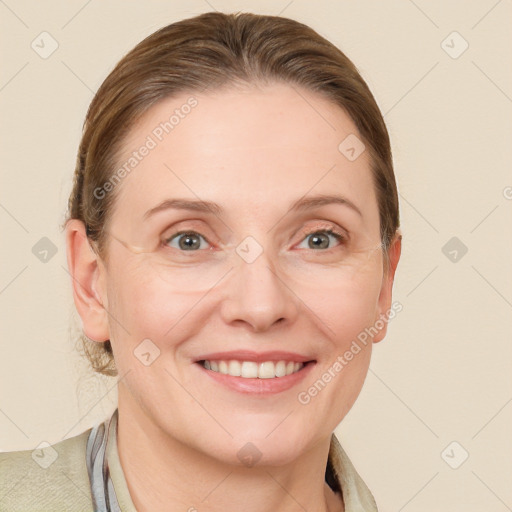 Joyful white adult female with medium  brown hair and blue eyes