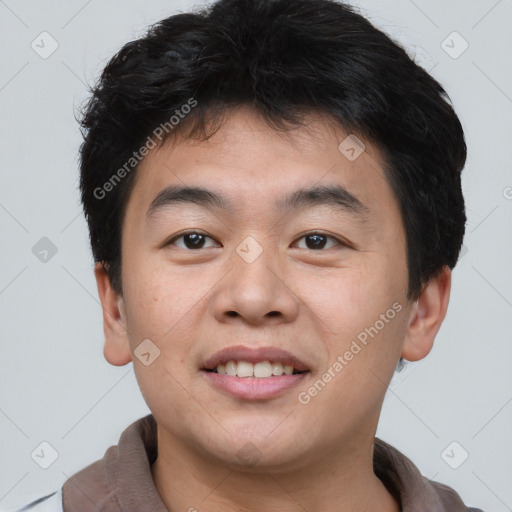 Joyful asian young-adult male with short  brown hair and brown eyes